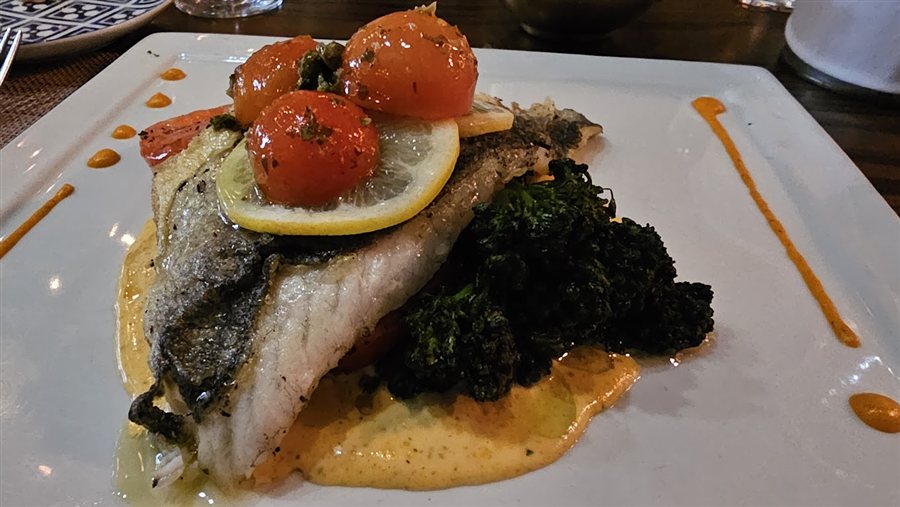Fish with roasted tomatoes, lemon and greens