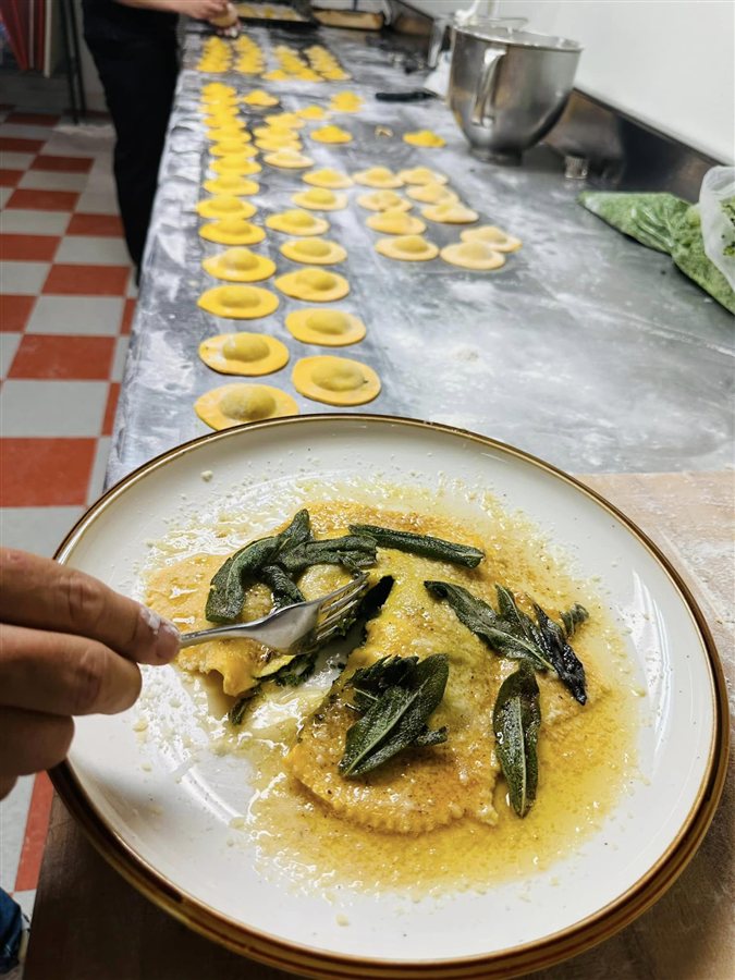 Fresh filled pasta on the kitchen counter beside a finished dish
